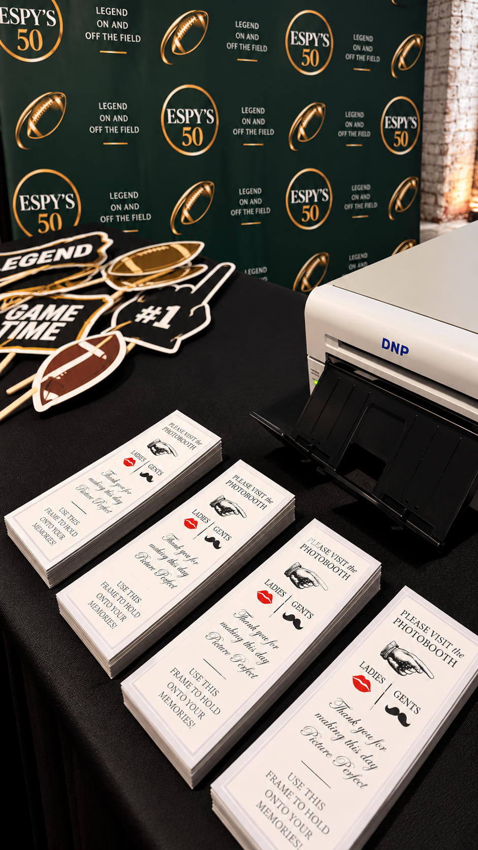 A Photo Bash Co. print station with a DNP printer, custom print frames and themed props